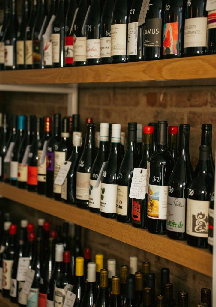 A variety of wine bottles displayed on wooden shelves in a Cincinnati store.